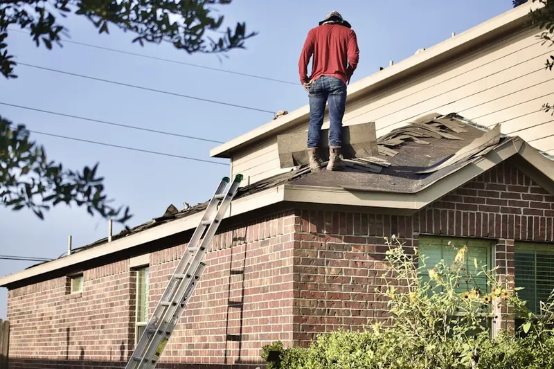 Professional roofer working on a residential roof in North Utica